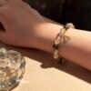 กำไลหินมงคล รูไทล์ควอตซ์ (Rutilated Quartz) เสริมการเงิน เปิดรับโอกาส จี้ซาฮะเงินแท้S925 รุ่นTrinity